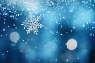 Detailed Snowflake Crystal Falling Against A Blurred Blue Background