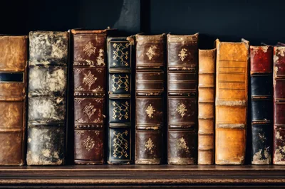 Row Of Antique Leather Bound Books On Shelf