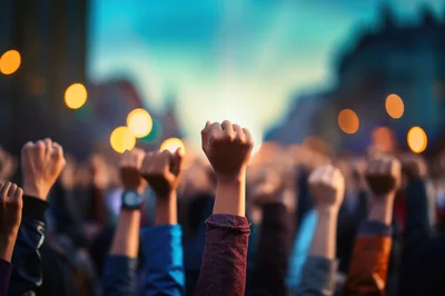 Crowd Raising Fists In Protest At Sunset