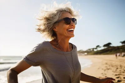 Happy Mature Woman Running On A Sunny Beach