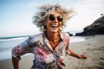 Happy Mature Woman Running On The Beach