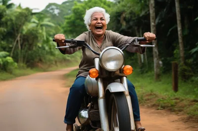 Joyful Elderly Woman Riding A Motorcycle On Rural Road