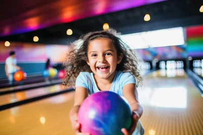 Happy Young Girl Holding Bowling Ball