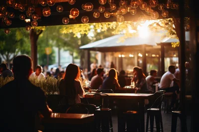 People Dining At An Outdoor Restaurant At Sunset