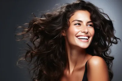 Portrait Of A Smiling Woman With Flowing Curly Hair