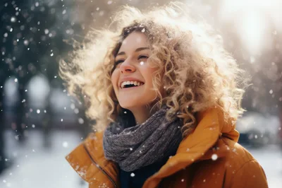 Happy Young Woman With Curly Hair Enjoying Winter Snow