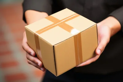 Delivery Person Holding A Cardboard Package