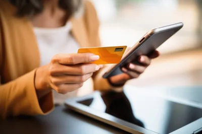 Woman Making Online Payment With Credit Card And Smartphone