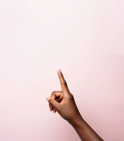 Dark Skinned Hand Pointing Upward Against Pink Background