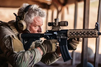 Tactical Shooter Aiming Rifle at Indoor Firing Range