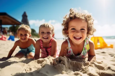 Three Happy Children Playing Together On A Sunny Beach