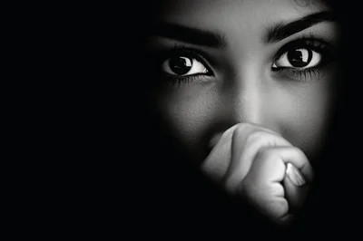 Close Up Portrait Of A Woman Covering Her Mouth
