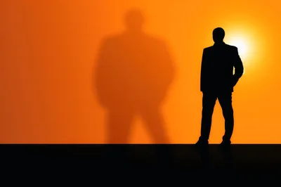 Silhouette Of A Businessman With A Large Shadow