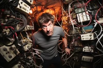 Confused Man Surrounded By Tangled Electronic Wires