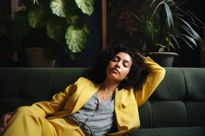 Young Woman Resting On A Green Sofa