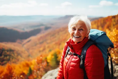 Senior Woman Hiking In Autumn Mountains