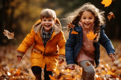 Happy Children Running Through Autumn Leaves