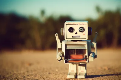 Vintage Toy Robot Standing On Sandy Ground