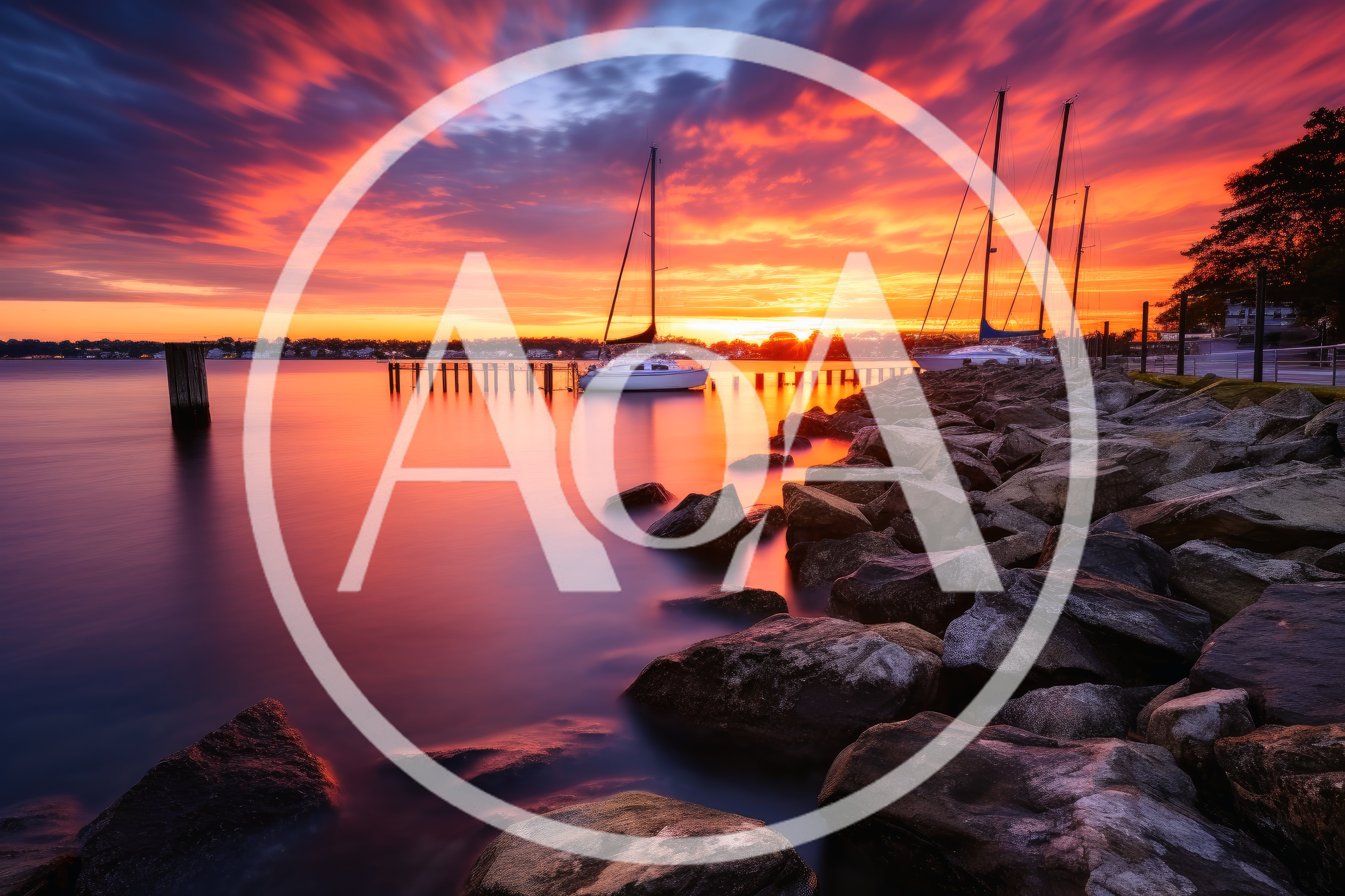 Sailboats Moored At A Rocky Shore During Sunset