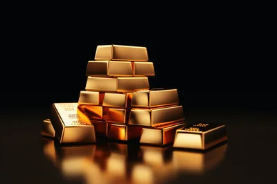Stack of Shiny Gold Bars on Dark Reflective Surface