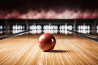 Red Bowling Ball Rolling Down A Wooden Lane