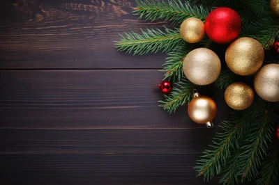 Christmas Ornaments and Pine Branches on Dark Wood