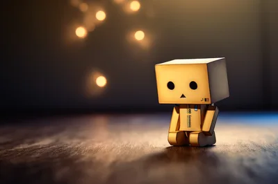 Danboard Cardboard Robot Figure Sitting On Wooden Floor