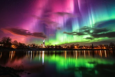 Vibrant Aurora Borealis Over A City Skyline At Night