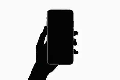 Silhouette Of A Hand Holding A Smartphone