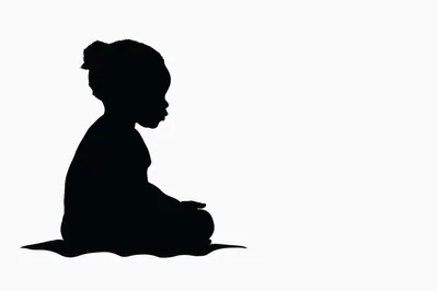Silhouette Of A Young Child Sitting Quietly