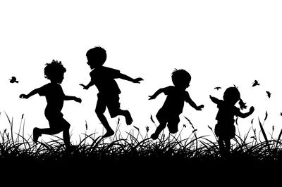 Silhouettes Of Children Playing In A Grassy Field