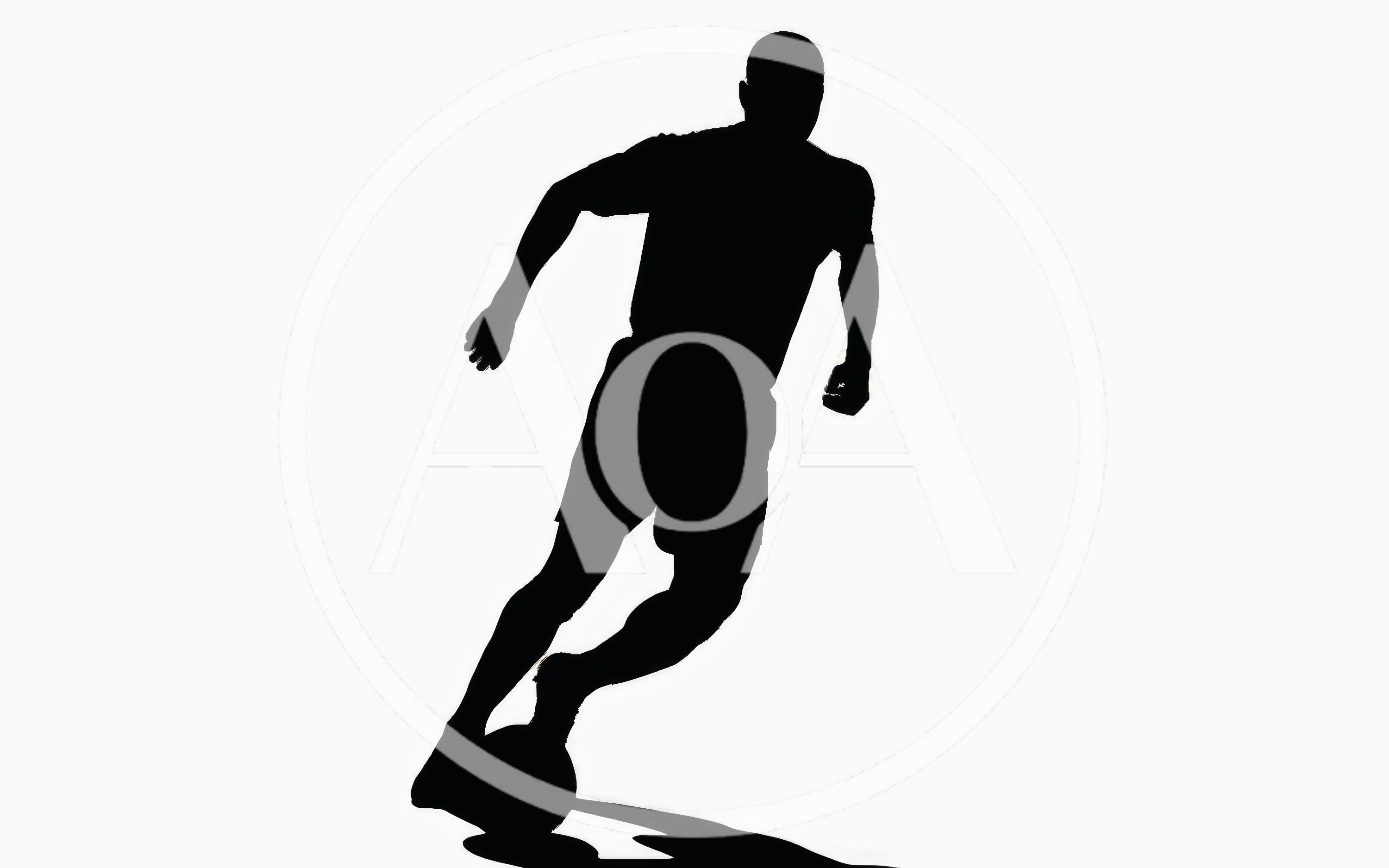 Silhouette Of A Soccer Player Dribbling A Ball