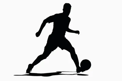 Silhouette Of A Soccer Player Dribbling A Ball