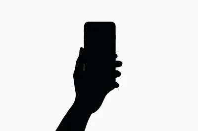 Silhouette Of A Hand Holding A Smartphone