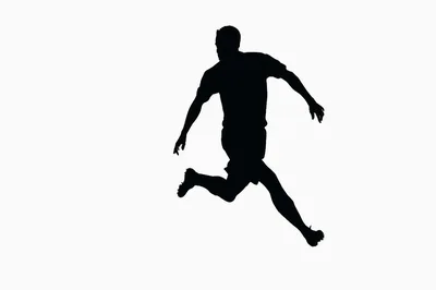 Silhouette Of A Soccer Player Running