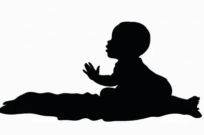 Silhouette Of A Baby Sitting On A Blanket