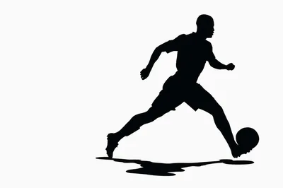 Silhouette Of A Soccer Player Dribbling A Ball