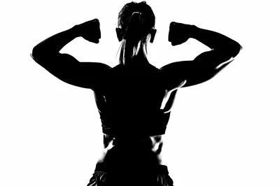 Silhouette Of A Muscular Woman Flexing Her Back Muscles