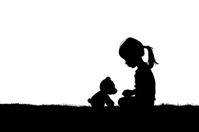 Silhouette Of A Little Girl Playing With A Teddy Bear