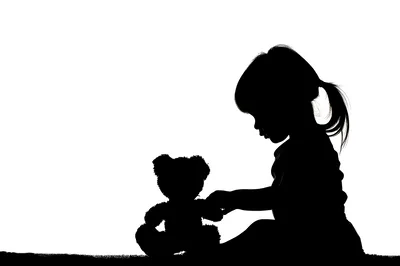 Silhouette Of A Little Girl Playing With Teddy Bear