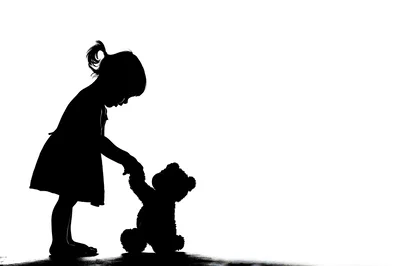 Silhouette Of A Little Girl Holding A Teddy Bear