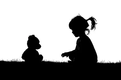 Silhouette of a Little Girl Playing with Teddy Bear