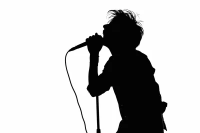 Silhouette Of A Male Singer Performing On Stage