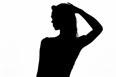 Silhouette of a Woman Posing Against White Background