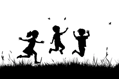 Silhouettes of Children Playing and Jumping in Grass