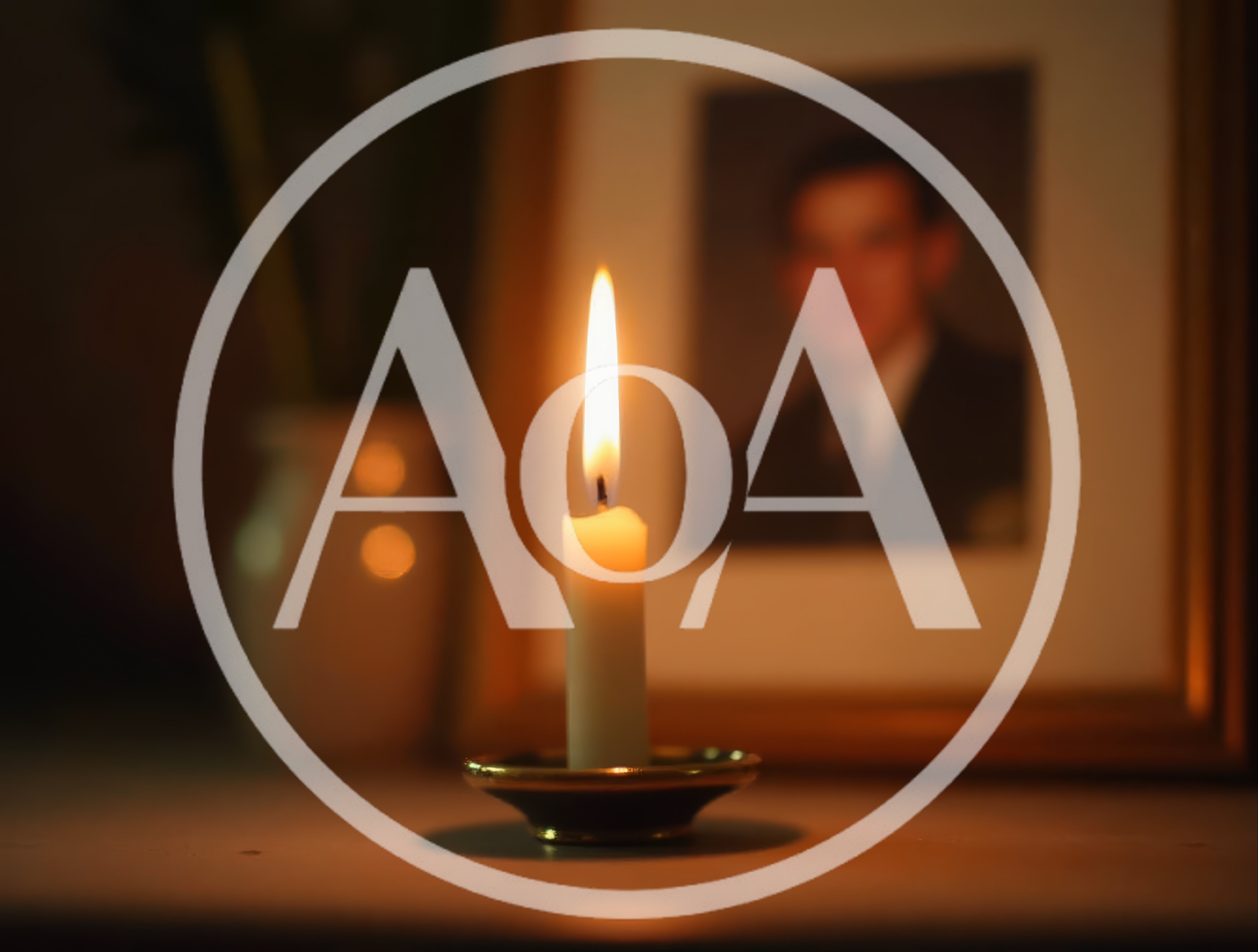 Lit Candle Placed Before A Framed Portrait