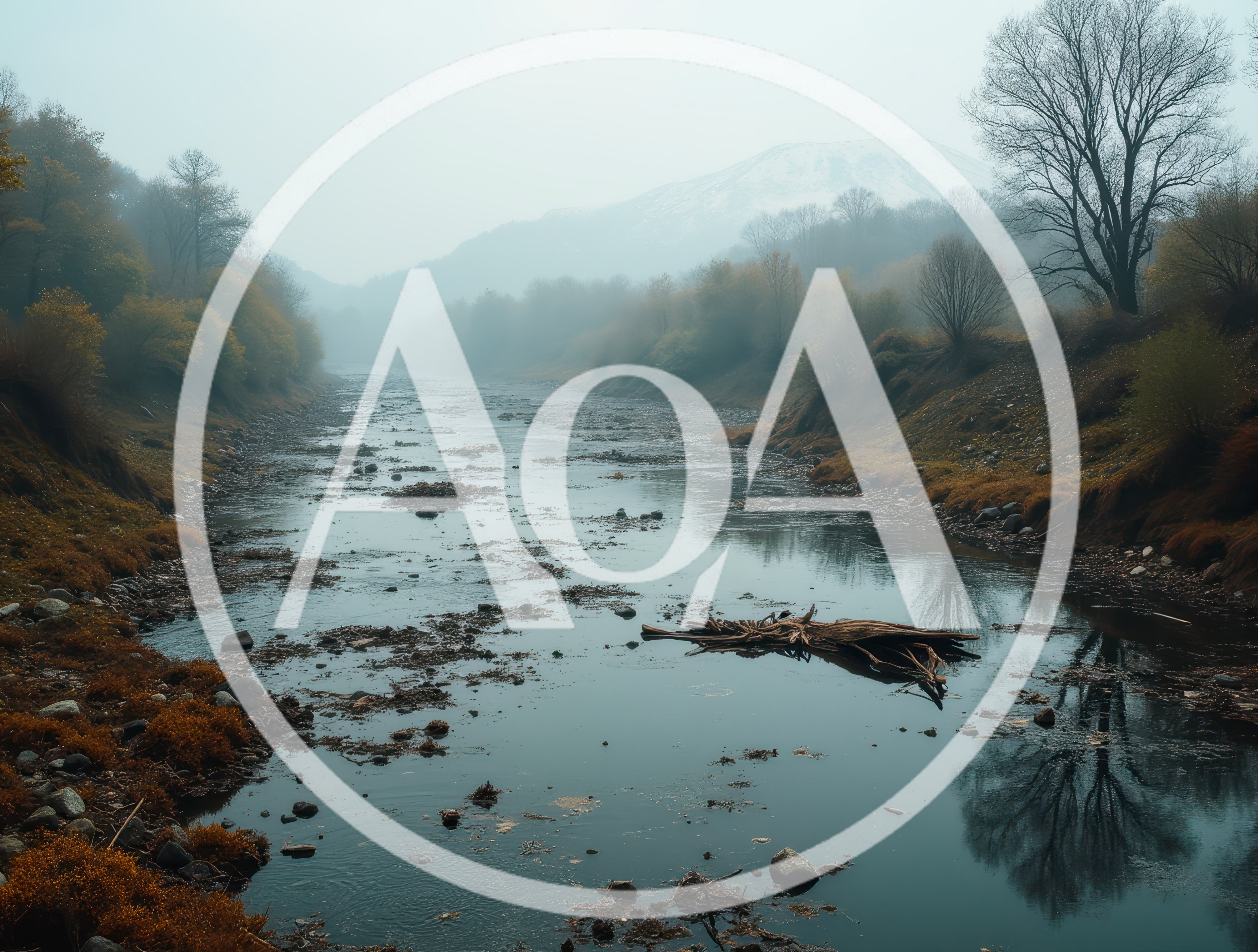 Foggy River Landscape With Distant Snow Capped Mountain