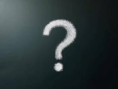 White Chalk Question Mark On A Dark Blackboard