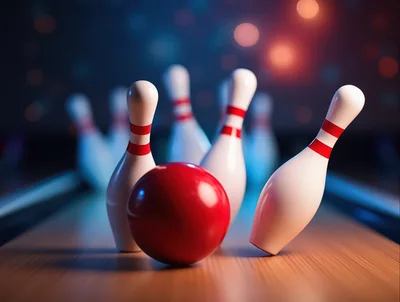 Red Bowling Ball Striking Pins On Lane