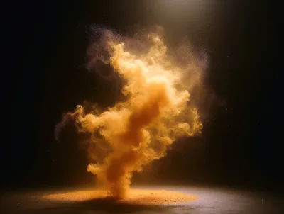Golden Powder Explosion Against Dark Background